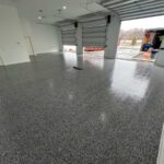 1,180 sq. ft. garage floor coating in Wyoming, MN featuring Quartzsite flake finish and Rapid Shield polyurea system by Grizzly Concrete Coatings.